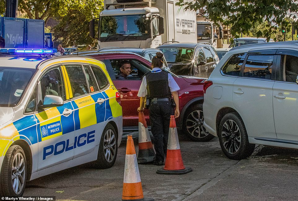 48463875-10034233-Police_intervene_at_an_Esso_garage_in_Rayners_Lane_as_high_queue-m-37_163276558817