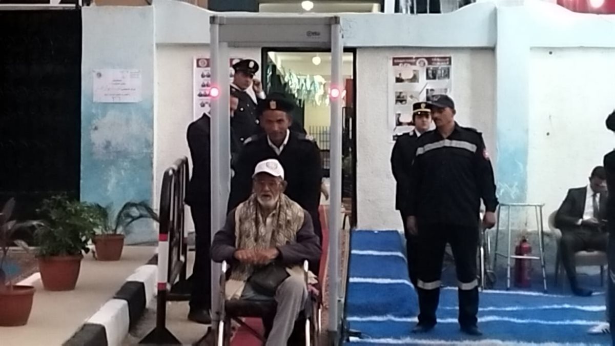 رجال أمن الإسماعيلية يعاونون ناخب في الوصول للجنته الانتخابية، فيتو