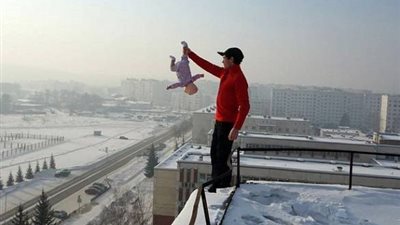 بالفيديو والصور.. الشهرة تدفع روسي للمخاطرة بحياة طفله الرضيع