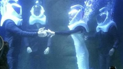 شاب يفاجئ عروسه بالزواج في حوض أسماك (فيديو وصور)