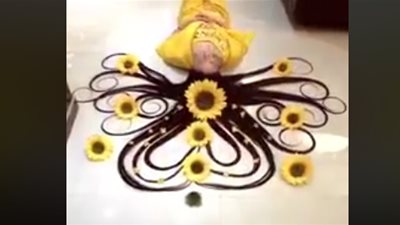 امرأة تجذب الآلاف بشعرها المغناطيسي (فيديو)