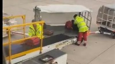 عامل مطار يرمي حقيبة مسافرة في الهواء (فيديو)