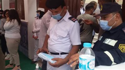 توزيع كمامات ومطهرات أمام إحدى اللجان الانتخابية في باب الشعرية