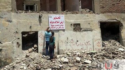 بالصور.. حي العجوزة يضع لافتات تحذيرية على أراضي الدولة
