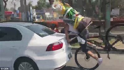 راكب دراجة يحمل تمثالا يصطدم بسيارة (فيديو وصور)