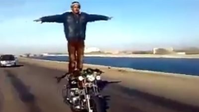 بالفيديو.. شاب يرقص فوق دراجته النارية على الطريق السريع