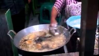 بالفيديو.. امرأة تغمس يديها العاريتين في الزيت المغلي لتقليب الطعام