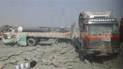 بالصور.. انقلاب سيارة محملة بالأسمنت أعلى الطريق الدائري