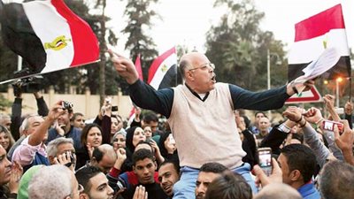 المتظاهرون يعلقون لافتة لشهداء 25 يناير أمام قصر الاتحادية