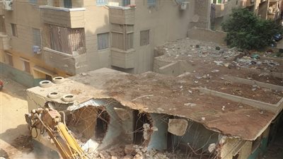 إزالة منشأة متعدية على خط تنظيم شارع المخزن بالعمرانية | صور