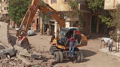 فتح شارع المكرونة بشمال الجيزة أمام المارة وإخلاء الجراجات به |صور