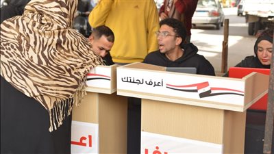 اعرف لجنتك، شباب يساعدون الناخبين على إيجاد لجانهم أمام مدرسة القومية بالعجوزة (صور)