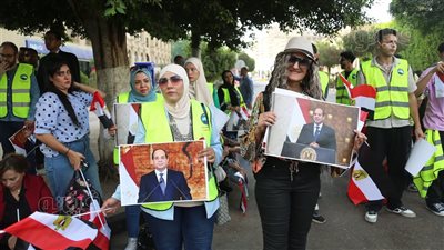 باللافتات وأعلام مصر، مواطنون ينتظرون وصول الرئيس السيسي للإدلاء بصوته بمصر الجديدة ( صور)