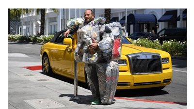 أمريكي يجوب الشوارع محملا بالنفايات لمكافحة الاستهلاك المفرط